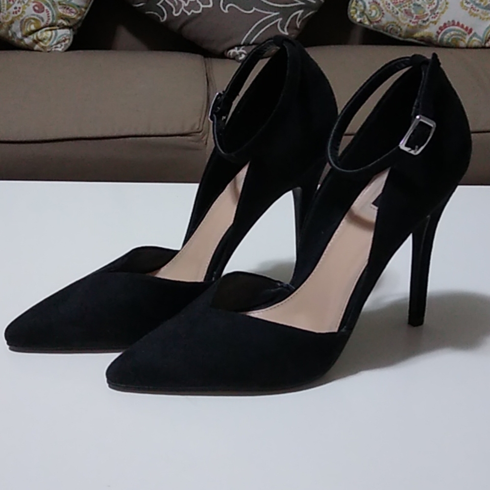 Black pointed-toe pumps with ankle strap